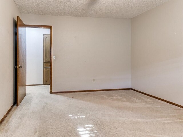 5201 SE 53rd St, Oklahoma City, OK 73135 - empty room with light carpet, a textured ceiling, and baseboards
