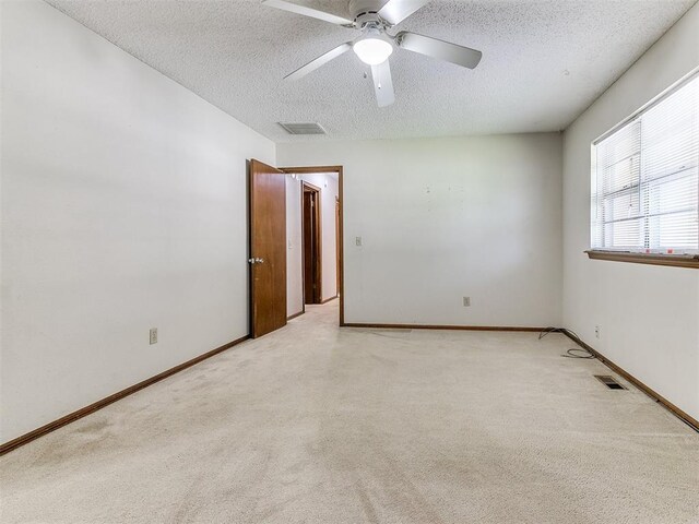 5201 SE 53rd St, Oklahoma City, OK 73135 - empty room with a textured ceiling, light colored carpet, ceiling fan, and baseboards