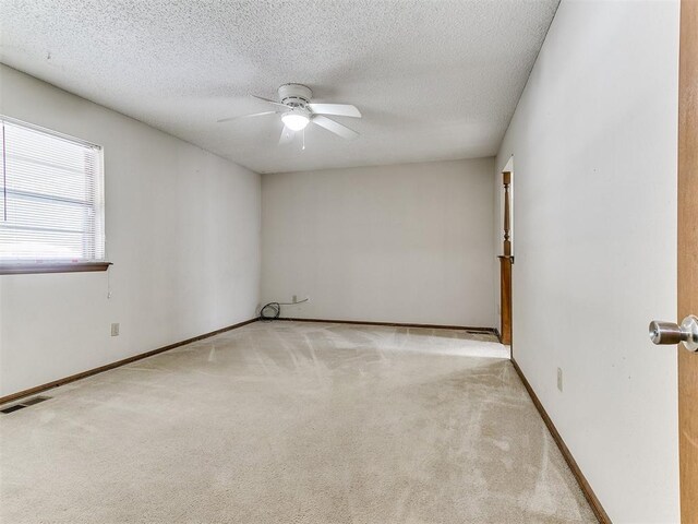 5201 SE 53rd St, Oklahoma City, OK 73135 - spare room with light colored carpet, ceiling fan, baseboards, and a textured ceiling