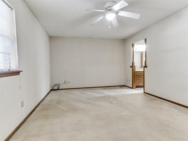 5201 SE 53rd St, Oklahoma City, OK 73135 - spare room featuring a ceiling fan, carpet floors, baseboards, and a textured ceiling