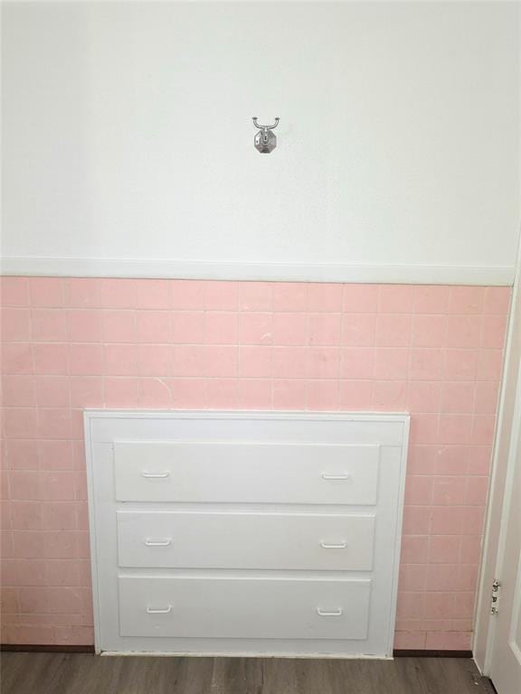 926 S 9th St, Chickasha, OK 73018 - detailed view of wood finished floors, tile walls, and a wainscoted wall