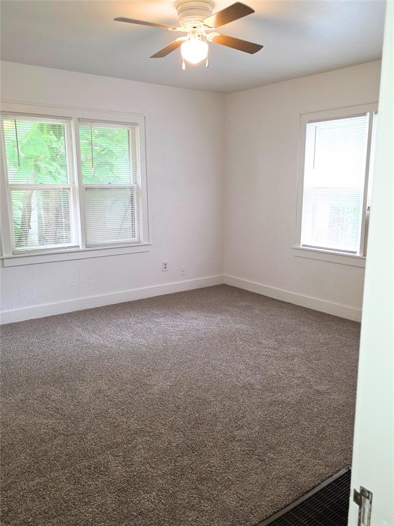 926 S 9th St, Chickasha, OK 73018 - carpeted spare room featuring baseboards and a ceiling fan