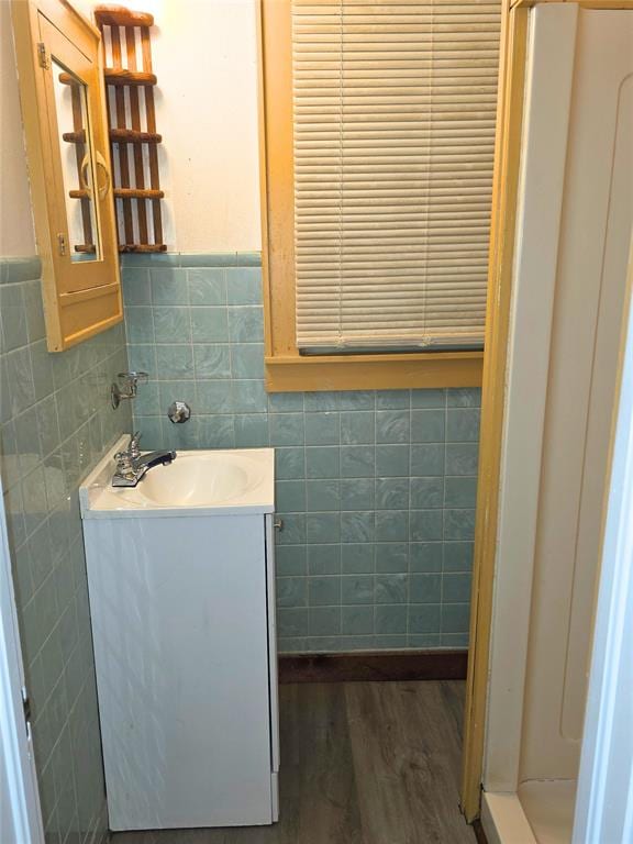 926 S 9th St, Chickasha, OK 73018 - bathroom featuring tile walls, vanity, wood finished floors, and wainscoting