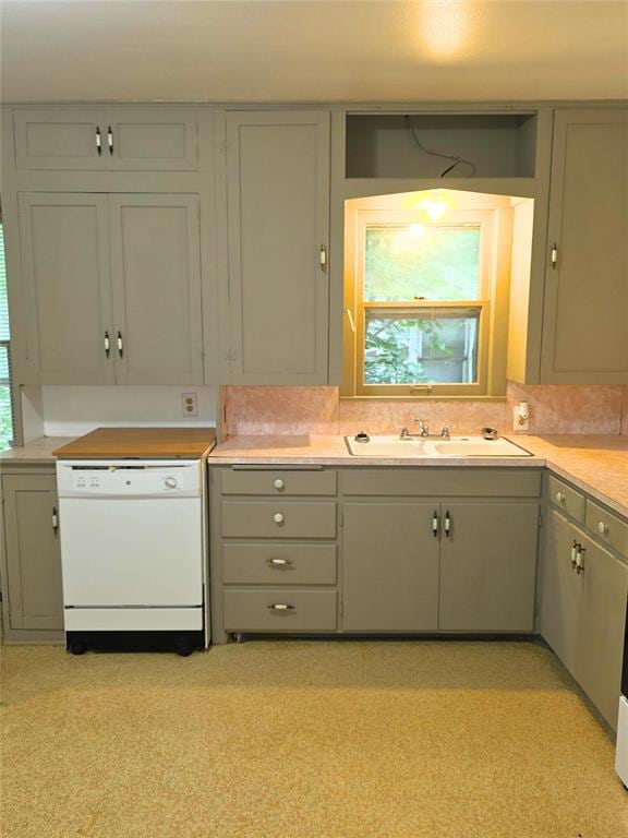 926 S 9th St, Chickasha, OK 73018 - kitchen with white dishwasher, light countertops, and gray cabinets