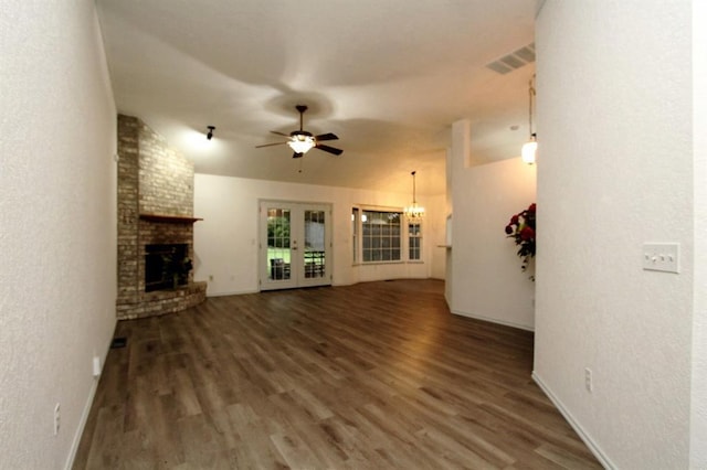 8113 Turtle Dove Dr, Oklahoma City, OK 73132 - unfurnished living room with a chandelier, wood finished floors, a brick fireplace, a textured wall, and ceiling fan
