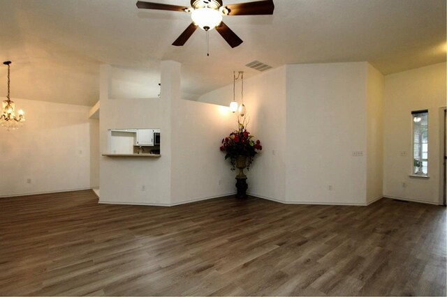 8113 Turtle Dove Dr, Oklahoma City, OK 73132 - unfurnished living room featuring vaulted ceiling, wood finished floors, a chandelier, and a ceiling fan