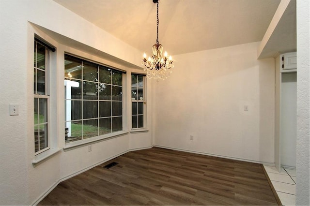8113 Turtle Dove Dr, Oklahoma City, OK 73132 - unfurnished dining area featuring a chandelier and wood finished floors