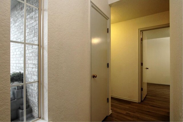 8113 Turtle Dove Dr, Oklahoma City, OK 73132 - corridor featuring a textured wall and wood finished floors