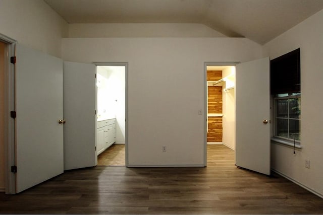 8113 Turtle Dove Dr, Oklahoma City, OK 73132 - unfurnished bedroom featuring a spacious closet, wood finished floors, vaulted ceiling, connected bathroom, and a closet