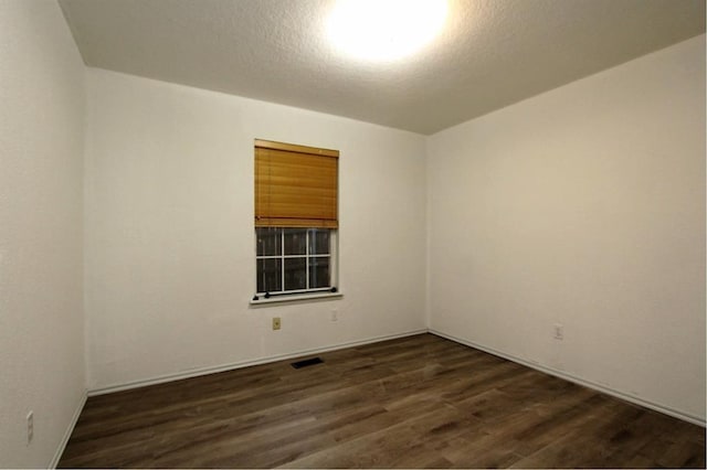 8113 Turtle Dove Dr, Oklahoma City, OK 73132 - unfurnished room with dark wood-style flooring and a textured ceiling