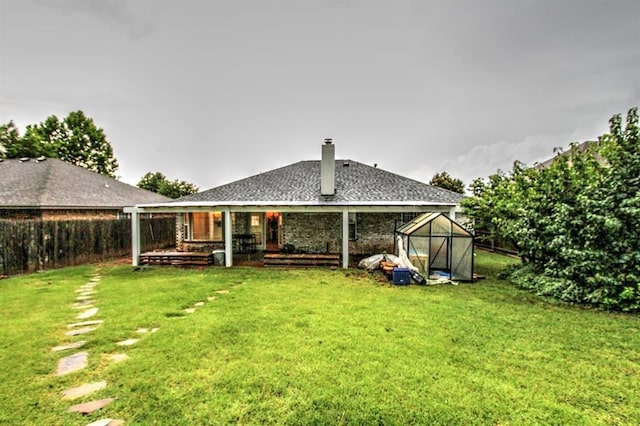 8113 Turtle Dove Dr, Oklahoma City, OK 73132 - back of property featuring a chimney, a greenhouse, and an outdoor structure