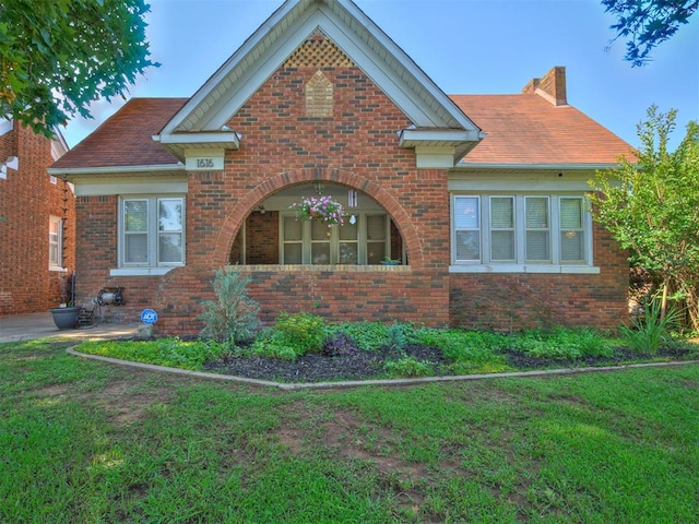 1616 NW 41st St, Oklahoma City, OK 73118 - view of home's exterior featuring brick siding, a yard, and a chimney
