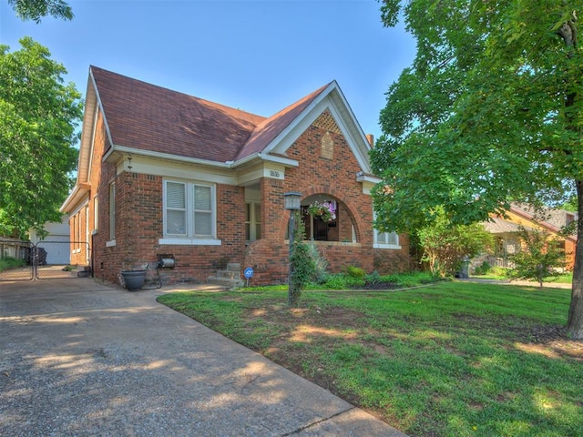 1616 NW 41st St, Oklahoma City, OK 73118 - view of front facade with brick siding, a shingled roof, and a front yard
