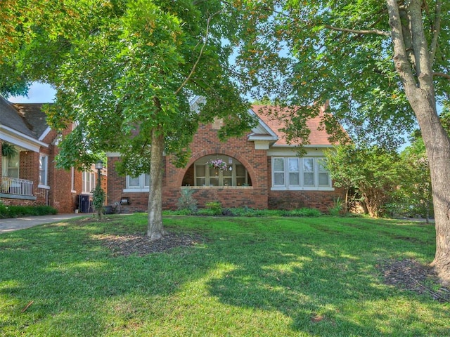 1616 NW 41st St, Oklahoma City, OK 73118 - view of front of house featuring brick siding, a front yard, and central AC unit