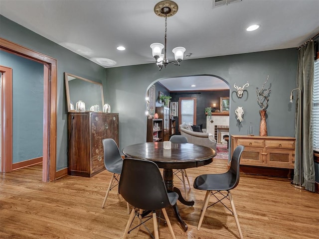 1616 NW 41st St, Oklahoma City, OK 73118 - dining area featuring arched walkways, light wood-style flooring, a chandelier, baseboards, and recessed lighting
