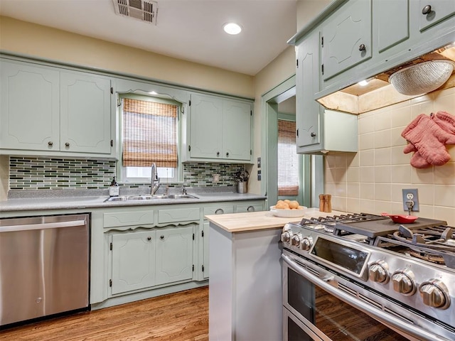 1616 NW 41st St, Oklahoma City, OK 73118 - kitchen featuring appliances with stainless steel finishes, a sink, tasteful backsplash, light countertops, and recessed lighting