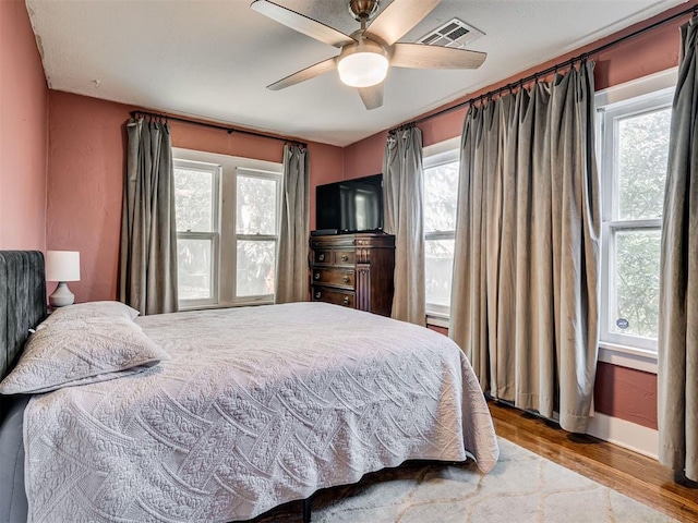 1616 NW 41st St, Oklahoma City, OK 73118 - bedroom with wood finished floors, multiple windows, baseboards, and ceiling fan