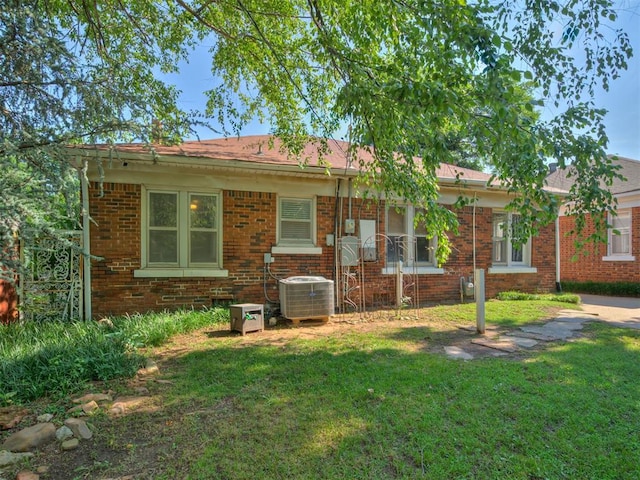 1616 NW 41st St, Oklahoma City, OK 73118 - view of front of house featuring a front lawn, cooling unit, and brick siding