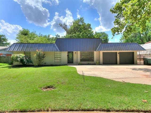 1117 Washington St, Edmond, OK 73034 - view of front of house with a garage, a metal roof, driveway, and brick siding