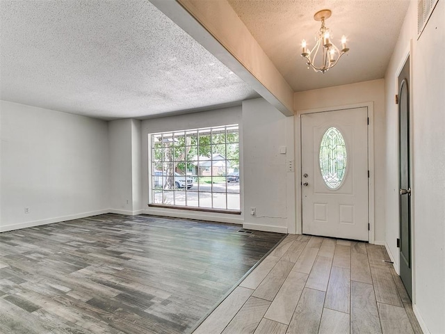 1117 Washington St, Edmond, OK 73034 - foyer entrance featuring a chandelier, wood finished floors, and a textured ceiling
