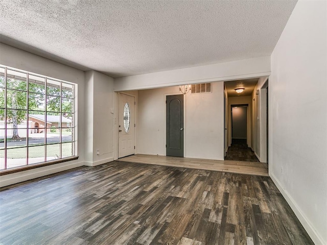 1117 Washington St, Edmond, OK 73034 - foyer featuring wood finished floors and a textured ceiling