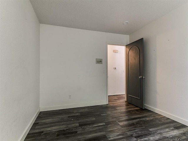 1117 Washington St, Edmond, OK 73034 - spare room with dark wood-style flooring and baseboards