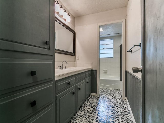 1117 Washington St, Edmond, OK 73034 - full bathroom with vanity, a textured ceiling, and bathtub / shower combination