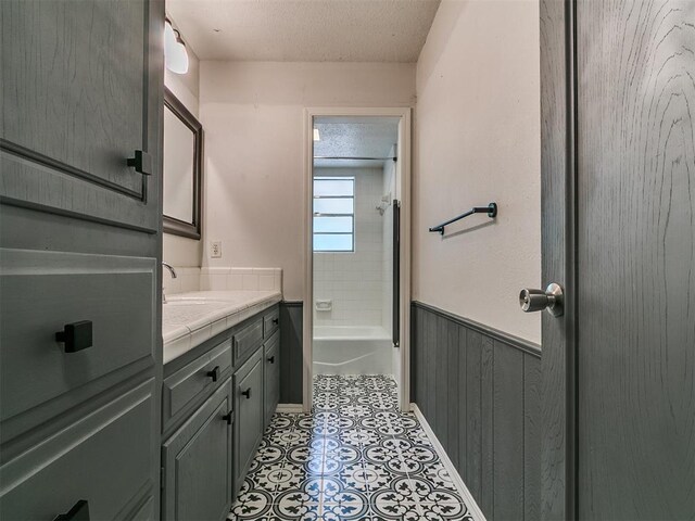 1117 Washington St, Edmond, OK 73034 - full bath with vanity, a textured ceiling, and a wainscoted wall