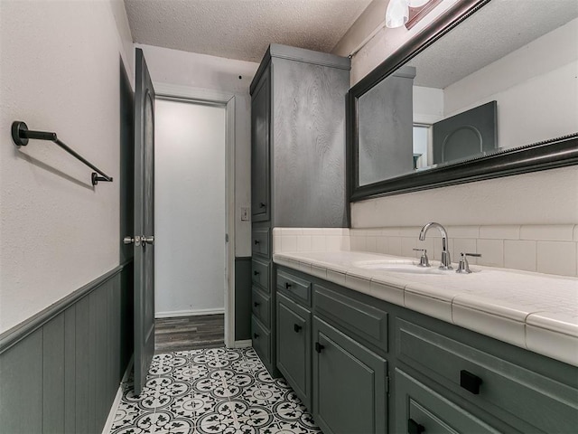 1117 Washington St, Edmond, OK 73034 - bathroom with vanity and a textured ceiling
