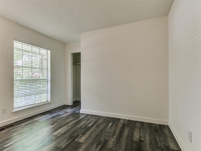 1117 Washington St, Edmond, OK 73034 - empty room with dark wood-type flooring and a textured ceiling