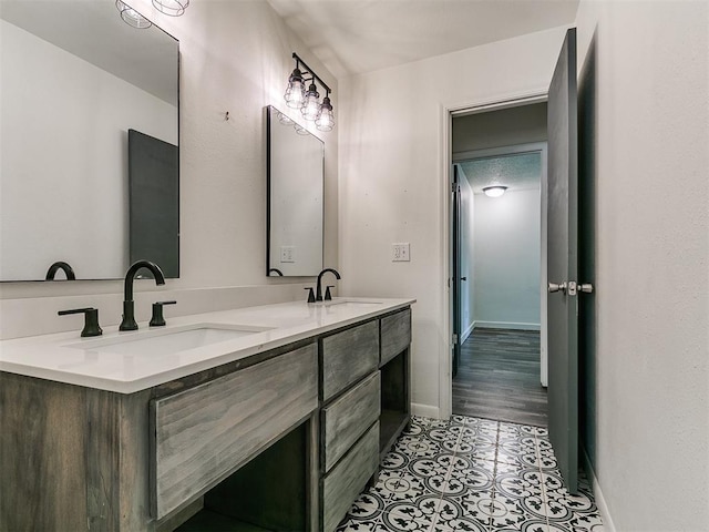 1117 Washington St, Edmond, OK 73034 - bathroom featuring double vanity and baseboards