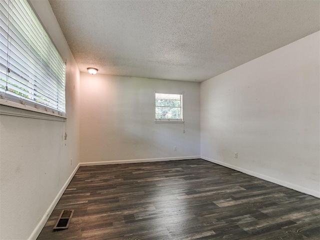 1117 Washington St, Edmond, OK 73034 - unfurnished room with a textured ceiling and wood finished floors