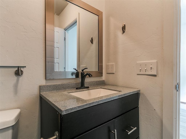 1117 Washington St, Edmond, OK 73034 - bathroom featuring vanity and a textured wall