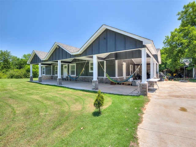 3 Antler Blvd, Mcloud, OK 74851 - back of house with board and batten siding, a yard, a patio area, and covered porch