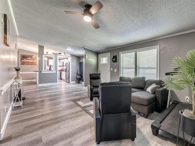 3 Antler Blvd, Mcloud, OK 74851 - living room with a textured ceiling, light wood-type flooring, ceiling fan, and vaulted ceiling