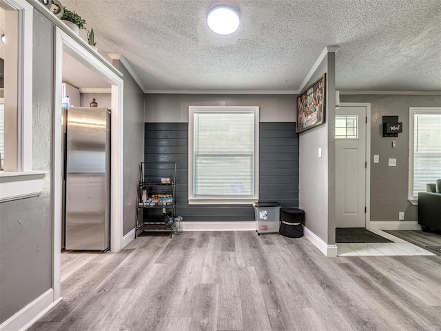 3 Antler Blvd, Mcloud, OK 74851 - foyer with wood finished floors, ornamental molding, a textured ceiling, and baseboards
