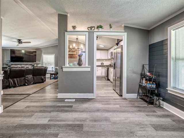 3 Antler Blvd, Mcloud, OK 74851 - living room featuring a textured ceiling, crown molding, a ceiling fan, wood finished floors, and baseboards