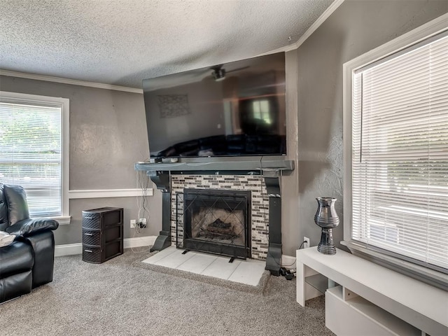 3 Antler Blvd, Mcloud, OK 74851 - carpeted living area featuring a textured ceiling, crown molding, a brick fireplace, baseboards, and a ceiling fan