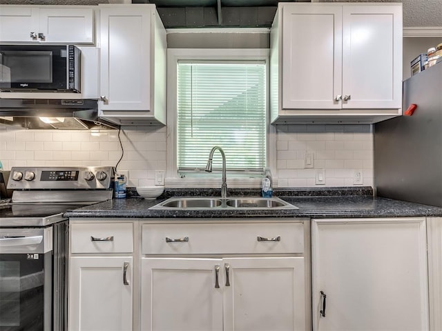 3 Antler Blvd, Mcloud, OK 74851 - kitchen featuring stainless steel range with electric stovetop, a sink, black microwave, white cabinets, and tasteful backsplash
