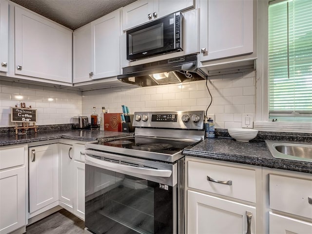 3 Antler Blvd, Mcloud, OK 74851 - kitchen featuring stainless steel electric stove, range hood, black microwave, white cabinetry, and decorative backsplash