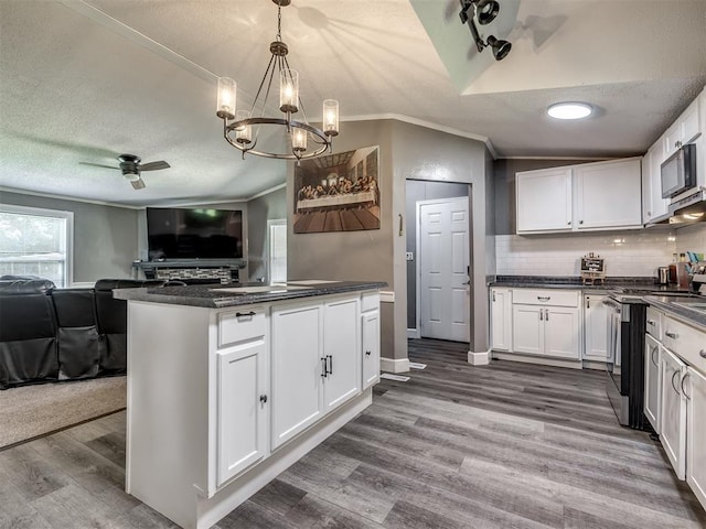 3 Antler Blvd, Mcloud, OK 74851 - kitchen featuring open floor plan, gas stove, dark countertops, white cabinets, and wood finished floors