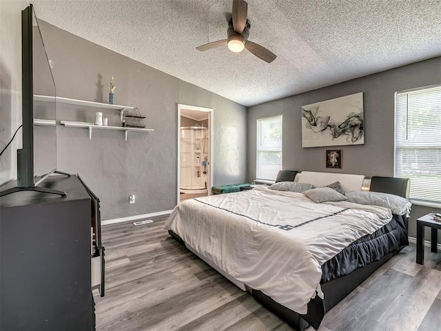 3 Antler Blvd, Mcloud, OK 74851 - bedroom with a textured ceiling, wood finished floors, multiple windows, lofted ceiling, and baseboards