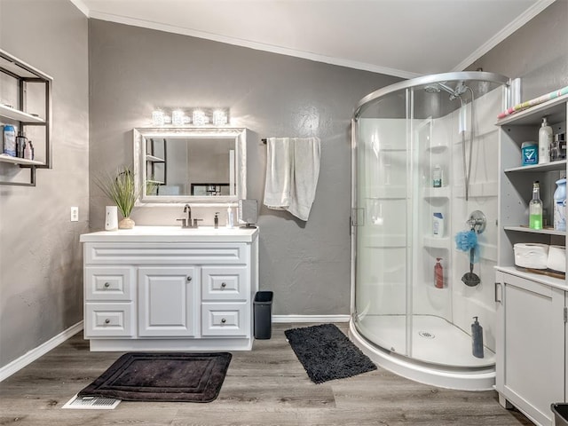 3 Antler Blvd, Mcloud, OK 74851 - bathroom featuring a stall shower, wood finished floors, vanity, crown molding, and baseboards
