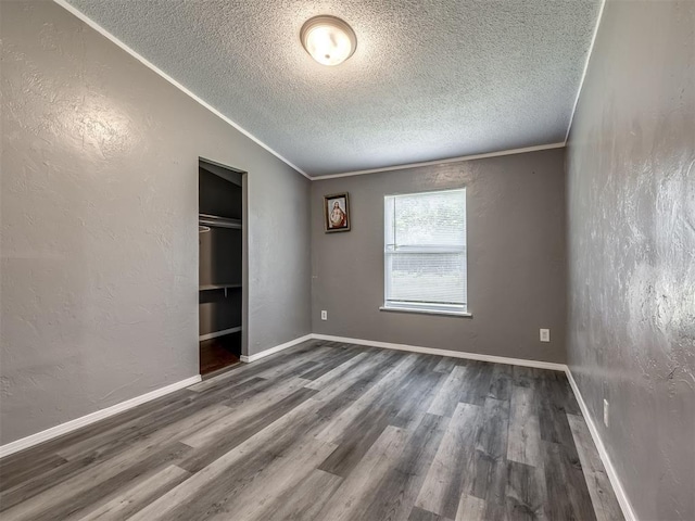 3 Antler Blvd, Mcloud, OK 74851 - unfurnished bedroom with a textured ceiling, wood finished floors, ornamental molding, a textured wall, and a closet