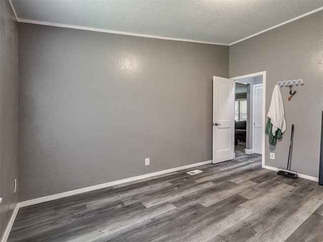 3 Antler Blvd, Mcloud, OK 74851 - empty room featuring ornamental molding, wood finished floors, a textured ceiling, and baseboards