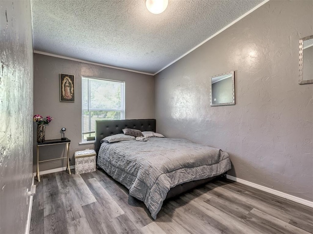 3 Antler Blvd, Mcloud, OK 74851 - bedroom with a textured wall, wood finished floors, a textured ceiling, ornamental molding, and baseboards