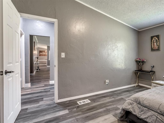 3 Antler Blvd, Mcloud, OK 74851 - bedroom with wood finished floors, a textured ceiling, a textured wall, baseboards, and crown molding