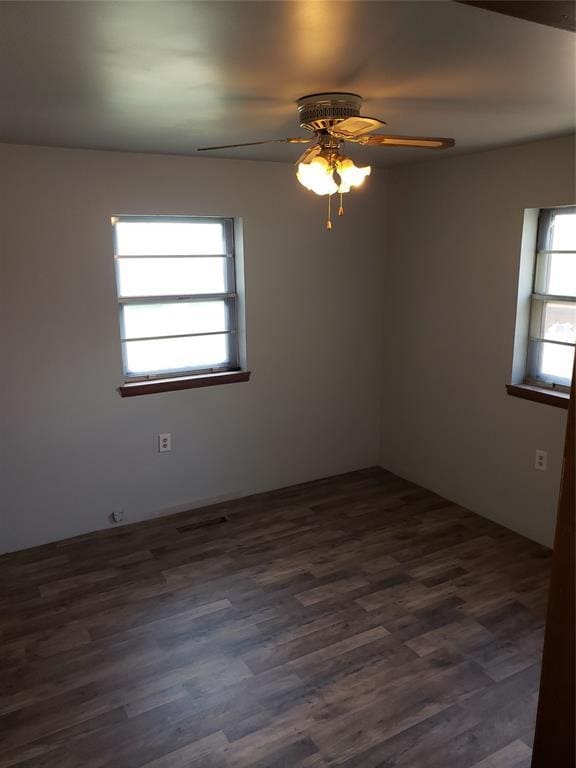 214 N Pecan St, Crescent, OK 73028 - spare room featuring ceiling fan and dark wood-style flooring
