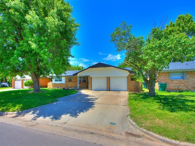 7017 S Miller Ave, Oklahoma City, OK 73159 - ranch-style home featuring brick siding, a garage, a front yard, and concrete driveway