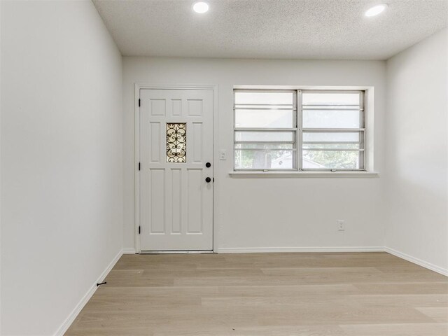 7017 S Miller Ave, Oklahoma City, OK 73159 - foyer entrance featuring light wood-style floors, recessed lighting, and a textured ceiling